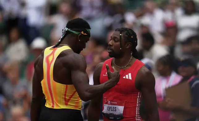 Noah Lyles and Kenny Bednarek talk after the men's 200-meter final at the U.S. Championships athletics meet in Eugene, Ore., Sunday, Aug. 3, 2025. (AP Photo/Abbie Parr)
