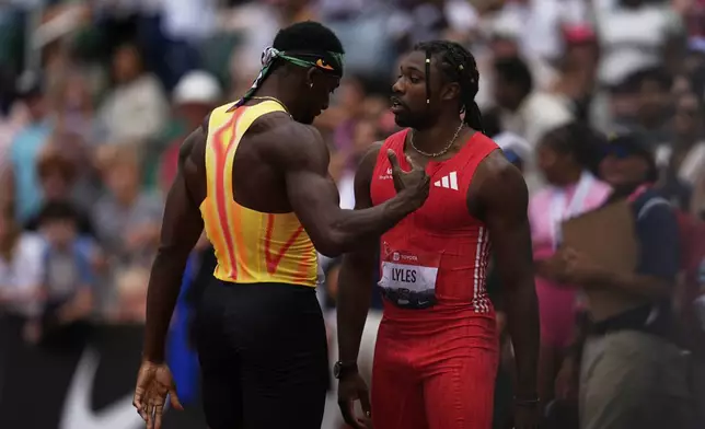 Noah Lyles and Kenny Bednarek talk after the men's 200-meter final at the U.S. Championships athletics meet in Eugene, Ore., Sunday, Aug. 3, 2025. (AP Photo/Abbie Parr)