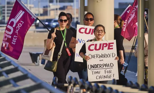 Air Canada flight attendants picket at Pearson International Airport in Toronto on Saturday, Aug. 16, 2025. (Sammy Kogan/The Canadian Press via AP)