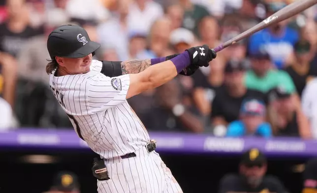 Colorado Rockies' Jordan Beck follows through with his swing after connecting for a three-run home run off Pittsburgh Pirates starting pitcher Paul Skenes in the sixth inning of a baseball game Saturday, Aug. 2, 2025, in Denver. (AP Photo/David Zalubowski)