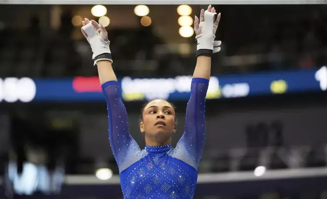 Hezly Rivera of WOGA reacts after competing on the uneven bars during the senior women's finals of the U.S. Gymnastics Championships in New Orleans, Sunday, Aug. 10, 2025. (AP Photo/Gerald Herbert)