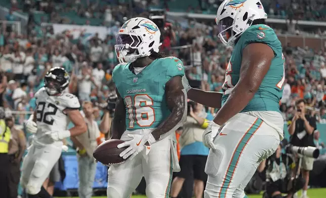 Miami Dolphins running back Mike Boone (16) celebrates after scoring a touchdown during the second half of an NFL preseason football game against the Jacksonville Jaguars, Saturday, Aug. 23, 2025, in Miami Gardens, Fla. (AP Photo/Rebecca Blackwell)