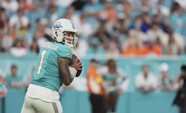 Miami Dolphins quarterback Tua Tagovailoa (1) looks to pass the football during the first half of an NFL preseason football game against the Jacksonville Jaguars, Saturday, Aug. 23, 2025, in Miami Gardens, Fla. (AP Photo/Rebecca Blackwell)