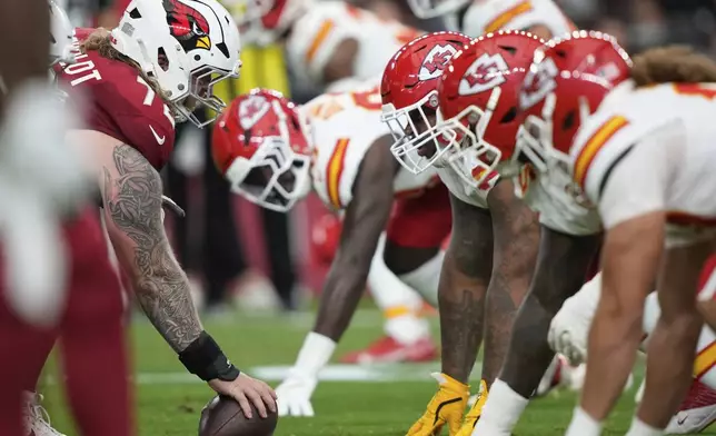 The Kansas City Chiefs line up as Arizona Cardinals guard Hjalte Froholdt (72) prepares to snap the ball during the first half of an NFL preseason football game, Saturday, Aug. 9, 2025, in Glendale. (AP Photo/Doug Benc)