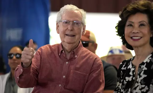 Sen. Mitch McConnell, R-Ky., and his wife, Elaine Chao, acknowledge applause at the annual Fancy Farm picnic Saturday, Aug. 2, 2025, in Fancy Farm, Ky. (AP Photo/Mark Humphrey)