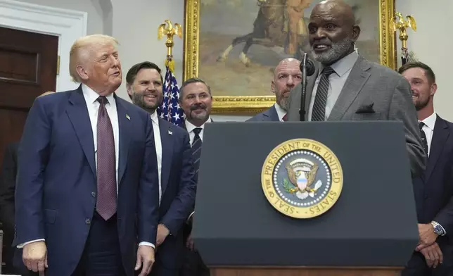 Former NFL football player Lawrence Taylor speaks as President Donald Trump, from left, Vice President JD Vance, Cody Campbell, WWE CCO Triple H and professional golfer Bryson DeChambeau listen during an event signing an executive order restarting the Presidential Fitness Test in public schools, Thursday, July 31, 2025, in the Roosevelt Room of the White House in Washington. (AP Photo/Jacquelyn Martin)