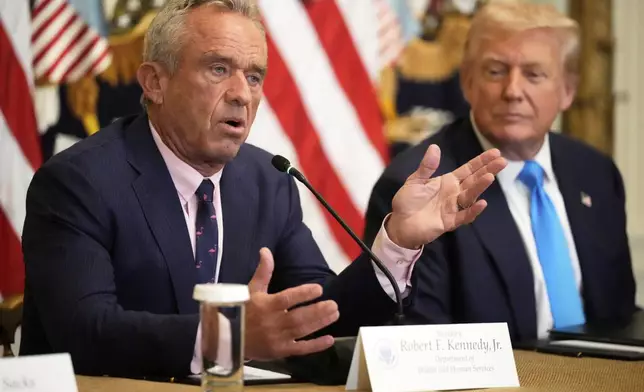 Health and Human Services Secretary Robert F. Kennedy Jr. speaks as President Donald Trump listens at an event to promote his proposal to improve Americans' access to their medical records in the East Room of the White House, Wednesday, July 30, 2025, in Washington. (AP Photo/Mark Schiefelbein)