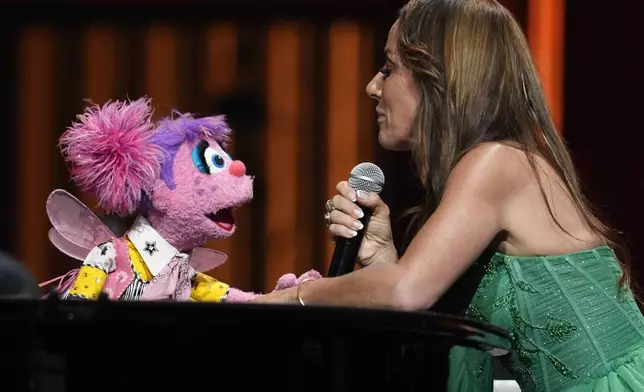 Sesame Streets' Abby Cadabby, left, performs with Tayla Lynn at the Grand Ole Opry, Thursday, Aug. 14, 2025, in Nashville, Tenn. (AP Photo/George Walker IV)