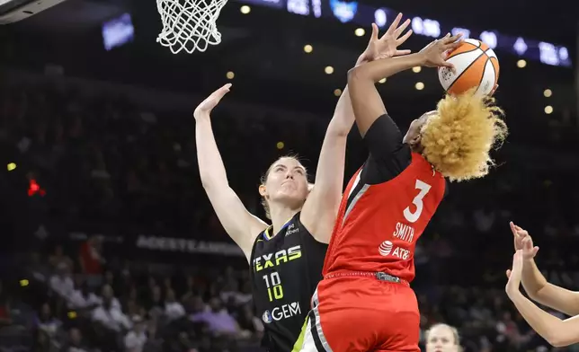 Dallas Wings center Luisa Geiselsoder (18) defends against Las Vegas Aces forward NaLyssa Smith (3) during the first half of a WNBA basketball game Sunday, Aug. 17, 2025, in Las Vegas. (Steve Marcus/Las Vegas Sun via AP)