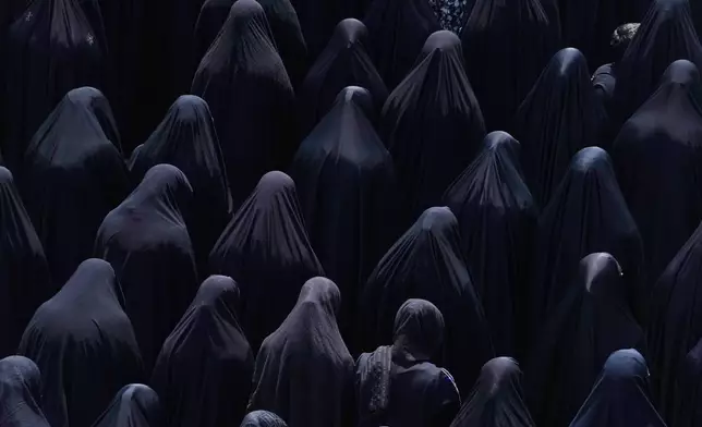 Shiite Muslim women pray at the shrine of Saint Abdulazim in Shahr-e-Ray, south of Tehran, Iran, Thursday, Aug. 14, 2025, during a ceremony to observe the Arbaeen, which marks the anniversary of the 40th day of mourning following the 7th century death of the Prophet Muhammad's grandson Hussein, who was killed in a battle in Karbala in present-day Iraq. (AP Photo/Vahid Salemi)