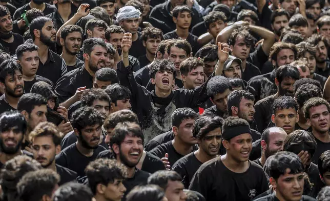 Shiite pilgrims participate in Arbaeen, which marks the end of the 40-day mourning period following Ashoura, in Karbala, Iraq, Thursday, Aug. 14, 2025. (AP Photo/Ammar Khalil)