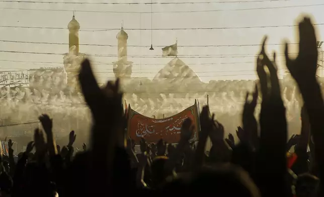 Shiite pilgrims participate in Arbaeen, which marks the end of the 40-day mourning period following Ashoura, in Karbala, Iraq, Thursday, Aug. 14, 2025. (AP Photo/Anmar Khalil)