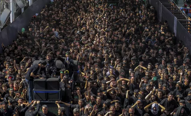 Shiite pilgrims participate in Arbaeen, which marks the end of the 40-day mourning period following Ashoura, in Karbala, Iraq, Thursday, Aug. 14, 2025. (AP Photo/Ammar Khalil)