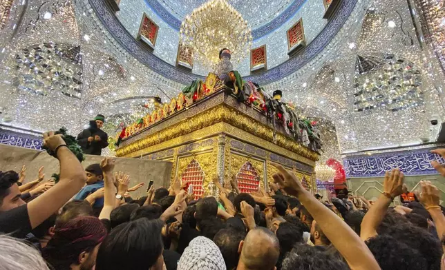 Shiite pilgrims mark the holiday of Arbaeen inside the holy shrine of Imam Abbas, which marks the end of the 40-day mourning period following Ashura, in Karbala, Iraq, Thursday, Aug. 15, 2025. (AP Photo/Hadi Mizban)
