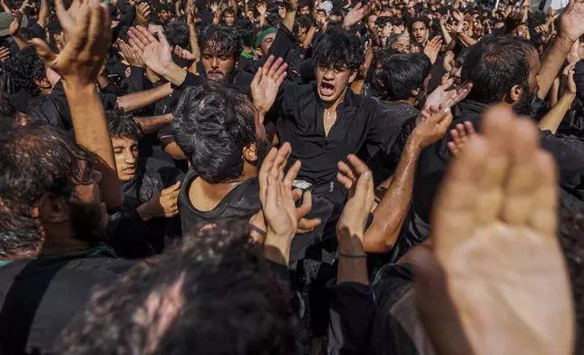 Shiite pilgrims participate in Arbaeen, which marks the end of the 40-day mourning period following Ashoura, in Karbala, Iraq, Thursday, Aug. 14, 2025. (AP Photo/Ammar Khalil)