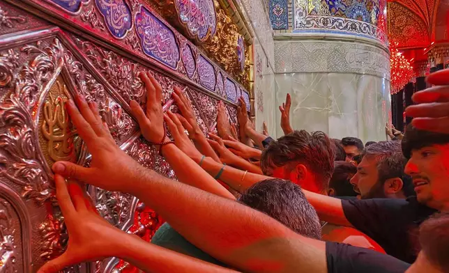 Shiite pilgrims mark the holiday of Arbaeen inside the holy shrine of Imam Hussein, which marks the end of the 40-day mourning period following Ashura, in Karbala, Iraq, Thursday, Aug. 15, 2025. (AP Photo/Hadi Mizban)