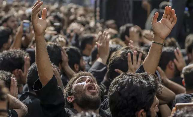 Shiite pilgrims participate in Arbaeen, which marks the end of the 40-day mourning period following Ashoura, in Karbala, Iraq, Thursday, Aug. 14, 2025. (AP Photo/Ammar Khalil)