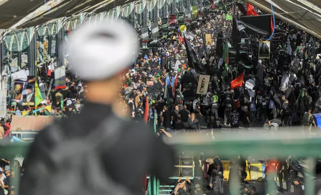 Shiite pilgrims participate in Arbaeen, which marks the end of the 40-day mourning period following Ashoura, in Karbala, Iraq, Thursday, Aug. 14, 2025. (AP Photo/Ammar Khalil)
