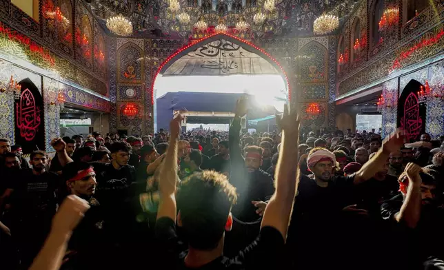 Shiite pilgrims participate in Arbaeen, which marks the end of the 40-day mourning period following Ashoura, in Karbala, Iraq, Thursday, Aug. 14, 2025. (AP Photo/Anmar Khalil)