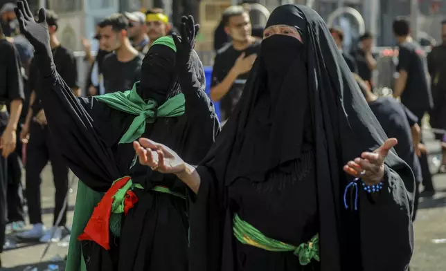 Shiite pilgrims women pray during Arbaeen, which marks the end of the 40-day mourning period following Ashoura, in Karbala, Iraq, Thursday, Aug. 14, 2025. (AP Photo/Ammar Khalil)
