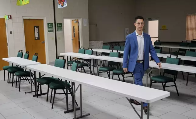 Felipe Sousa Lazaballet, executive director of the Hope Community Center walks through an area that can be set up for feeding families if they were to encounter a disaster Thursday, Aug. 14, 2025, in Apopka, Fla. (AP Photo/John Raoux)