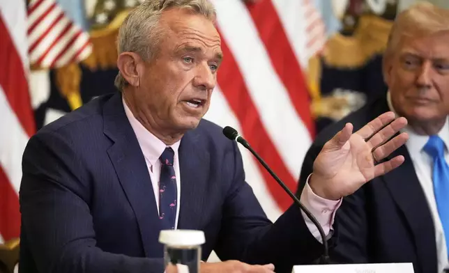 Health and Human Services Secretary Robert F. Kennedy Jr. speaks as President Donald Trump listens at an event to promote his proposal to improve Americans' access to their medical records in the East Room of the White House, Wednesday, July 30, 2025, in Washington. (AP Photo/Mark Schiefelbein)