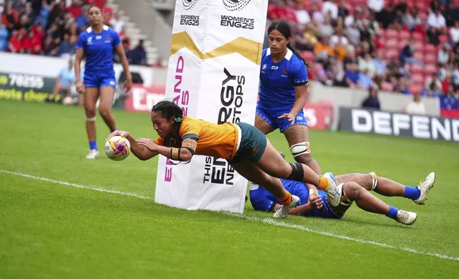 Australia's Cecilia Smith scores their side's eighth try of the game during the Women's Rugby World Cup 2025 Pool A match at the Salford Community Stadium in Salford, England, Saturday, Aug. 23, 2025. (Mike Egerton/PA via AP)