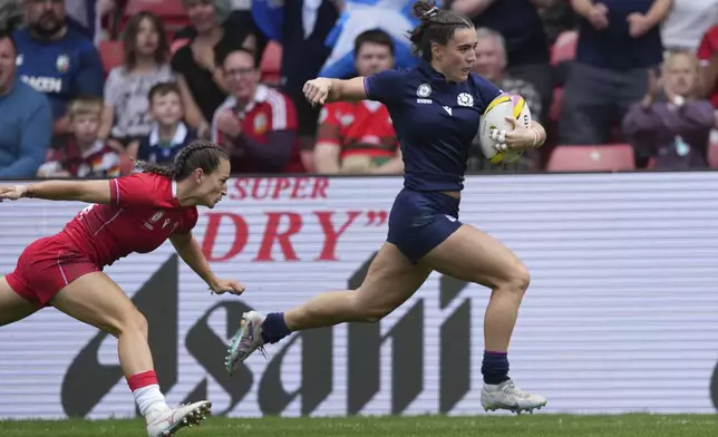 Scotland's Francesca McGhie runs on her way to score a try during the group B match at the 2025 Women's Rugby World Cup between Scotland and Wales in Manchester, England, Saturday, Aug. 23, 2025. (AP Photo/Dave Shopland)
