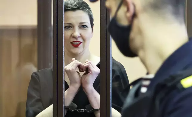 FILE - Belarus opposition activist Maria Kolesnikova stands behind bars in a defendants' cage in a court in Minsk, Belarus, on Aug. 4, 2021. (Ramil Nasibulin/BelTA Pool Photo via AP, File)