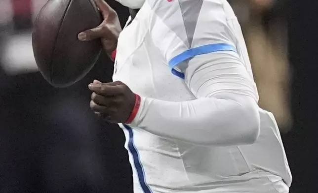 Tennessee Titans quarterback Cameron Ward (1) looks to throw a pass during the first half of a preseason NFL football game against the Atlanta Falcons, Friday, Aug. 15, 2025, in Atlanta. (AP Photo/Mike Stewart)