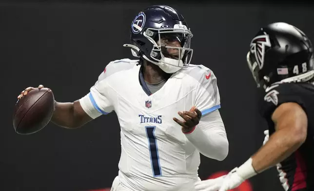 Tennessee Titans quarterback Cameron Ward (1) looks to throw a pass during the first half of a preseason NFL football game against the Atlanta Falcons, Friday, Aug. 15, 2025, in Atlanta. (AP Photo/Brynn Anderson)