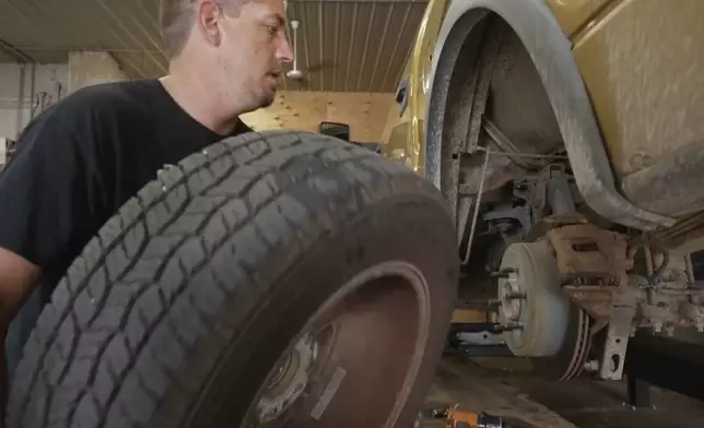 Mechanic Chad Volk works on a vehicle in his shop in Lake Crystal, Minn., on Aug. 14 2025. (AP Photo/Mark Vancleave)