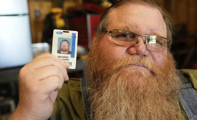 Richard Guilford poses for a portrait with an ID card from his recently recovered wallet that he lost 11 years ago Thursday, Aug. 14, 2025, in Petersburg, Mich. (AP Photo/Ryan Sun)
