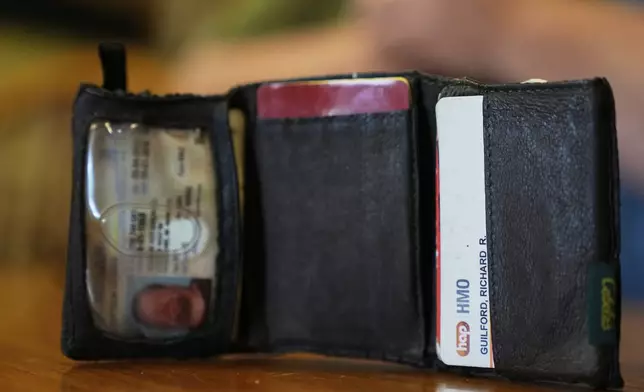 The old wallet of Richard Guilford is seen as he speaks during an interview Thursday, Aug. 14, 2025, in Petersburg, Mich. (AP Photo/Ryan Sun)