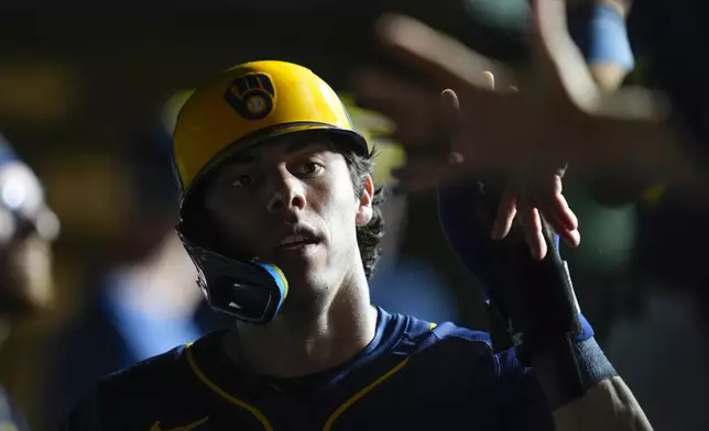 Milwaukee Brewers designated hitter Christian Yelich celebrates after scoring on a single from Brice Turang during the sixth inning of a baseball game against the Chicago Cubs, Wednesday, Aug. 20, 2025, in Chicago. (AP Photo/Erin Hooley)