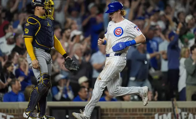 Chicago Cubs' Owen Caissie scores on a double from Michael Busch during the third inning of a baseball game against the Milwaukee Brewers, Wednesday, Aug. 20, 2025, in Chicago. (AP Photo/Erin Hooley)
