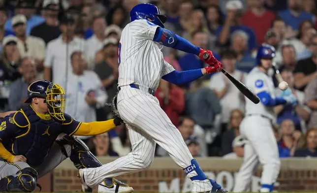 Chicago Cubs' Michael Busch hits a three-run double during the third inning of a baseball game against the Milwaukee Brewers, Wednesday, Aug. 20, 2025, in Chicago. (AP Photo/Erin Hooley)