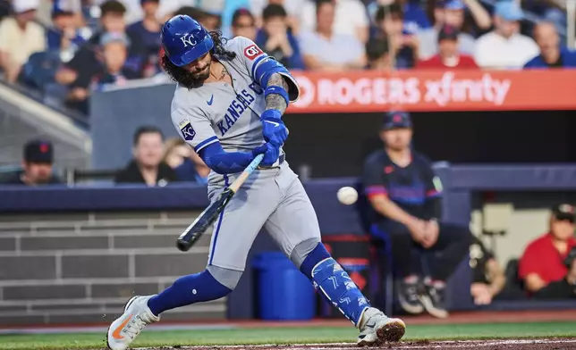 Kansas City Royals' Jonathan India hits a double against the Toronto Blue Jays during third-inning baseball game action in Toronto, Friday, Aug. 1, 2025. (Sammy Kogan/The Canadian Press via AP)