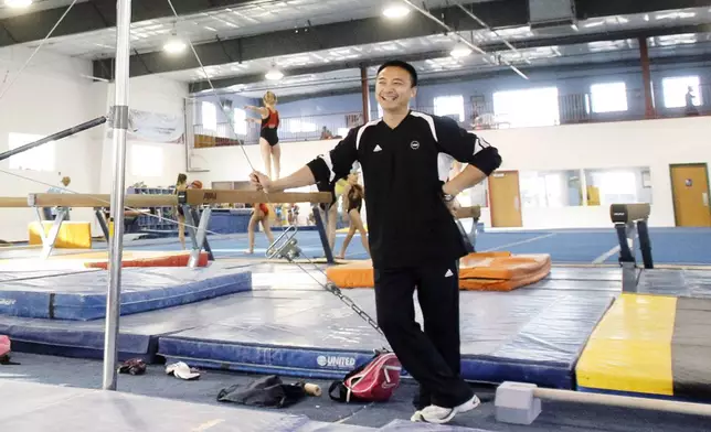 FILE - Coach Liang "Chow" Qiao is seen during a workout at Chow's Gymnastics on Nov. 15, 2010, in West Des Moines, Iowa. (AP Photo/Charlie Neibergall)