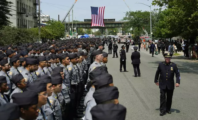 New York Police Academy cadets line the street outside the Parkchester Jame Masjid mosque for the funeral of officer Didular Islam, Thursday, July 31, 2025, in New York. (AP Photo/Yuki Iwamura )