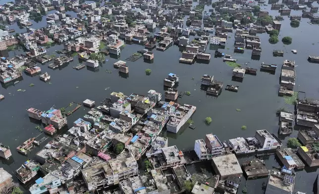 An aerial view of submerged houses on the banks of the river Ganga following heavy monsoon rains, in Prayagraj, India, Tuesday, Aug. 5, 2025. (AP Photo/Rajesh Kumar Singh)