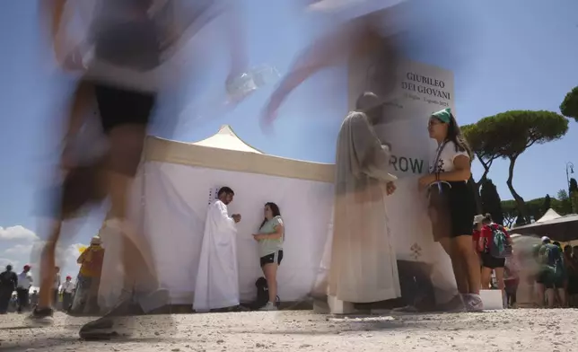 Young people participate in the Youth Jubilee can celebrate the penitential day and confess themselves in the confessionals set up for them in the Circus Maximus in Rome, Friday, Aug. 1, 2025. (AP Photo/Andrew Medichini)