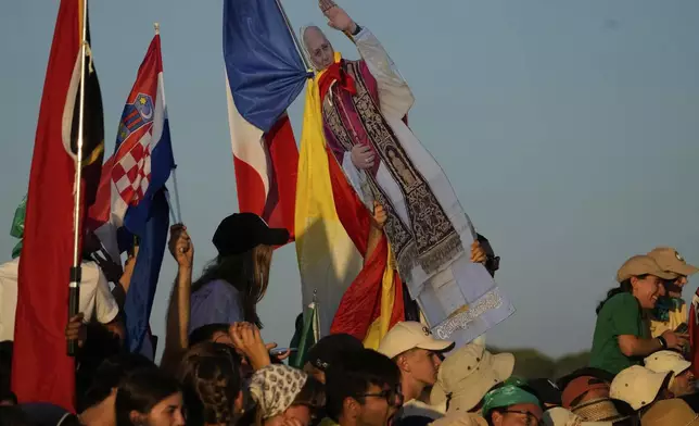 Young people attend for the prayer vigil with Pope Leo XIV in the Youths Jubilee at the Tor Vergata field in Rome, Saturday, Aug. 2, 2025. (AP Photo/Gregorio Borgia)