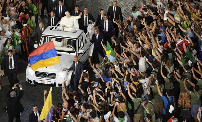 Pope Leo XIV greets faithful in St. Peter's Square at the end of a welcome mass for the Youth Jubilee at the Vatican, Tuesday, July 29, 2025. (AP Photo/Gregorio Borgia)