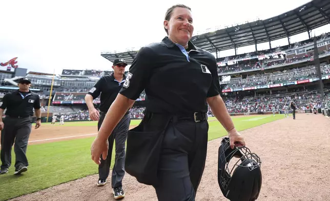 Home plate umpire Jen Pawol walks off the field after completing her first baseball game, between the Miami Marlins and the Atlanta Braves, Sunday, Aug. 10, 2025, in Atlanta. (AP Photo/Colin Hubbard)