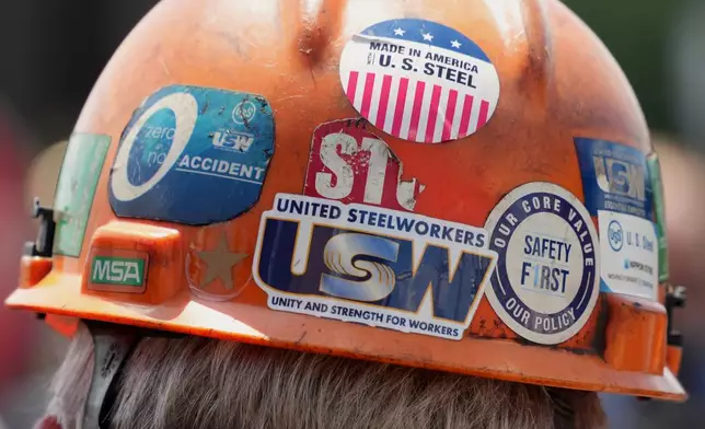 This is the back of the safety helmet worn by a steelworker listening to Pennsylvania Governor Josh Shapiro's meeting with media at the Clairton Coke Works, a U.S. Steel plant, in Clairton, Pa., Tuesday, Aug. 12, 2025. (AP Photo/Gene J. Puskar)