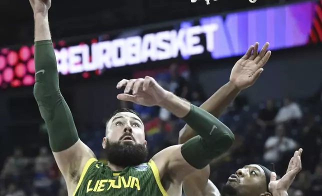 Lithuania's Jonas Valanciunas, left, and Britain's Dan Akin, right, challenge for the ball during the FIBA EuroBasket 2025 group B basketball match between Great Britain and Lithuania in Tampere, Finland, Wednesday, Aug. 27, 2025. (Heikki Saukkomaa/Lehtikuva via AP)