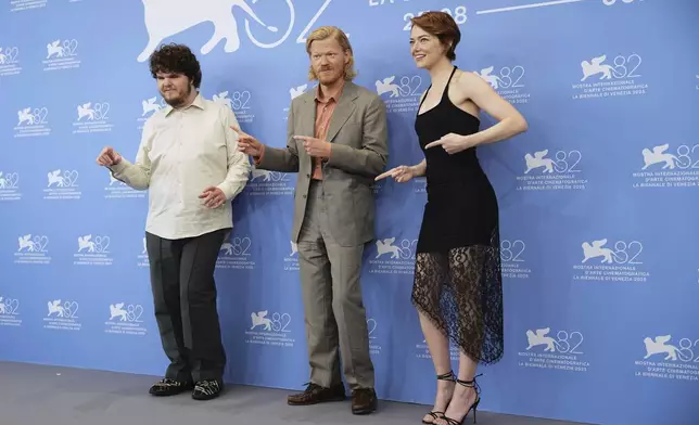 Aidan Delbis, from left, Jesse Plemons and Emma Stone pose for photographers at the photo call for the film 'Bugonia' during the 82nd edition of the Venice Film Festival in Venice, Italy, on Thursday, Aug. 28, 2025. (Photo by Scott A Garfitt/Invision/AP)