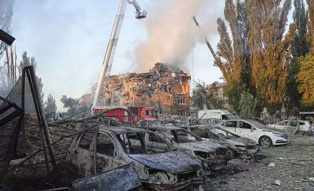 Firefighters work on the site of a burning building after a Russian attack in Kyiv, Ukraine, early Thursday, Aug. 28, 2025. (AP Photo/Efrem Lukatsky)
