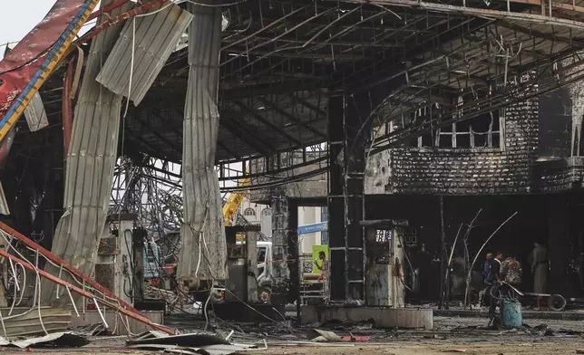 People inspect a damaged petrol station hit in Israeli airstrikes on Sunday, in Sanaa, Yemen, Monday, Aug. 25, 2025. (AP Photo)